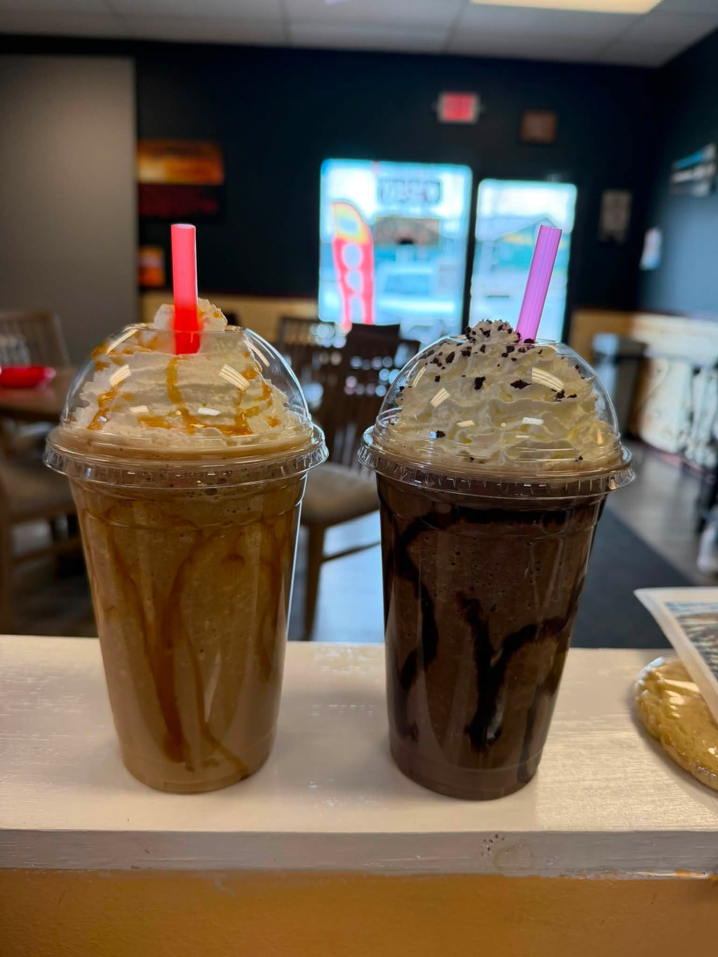 Two blended coffee frappes with whipped cream